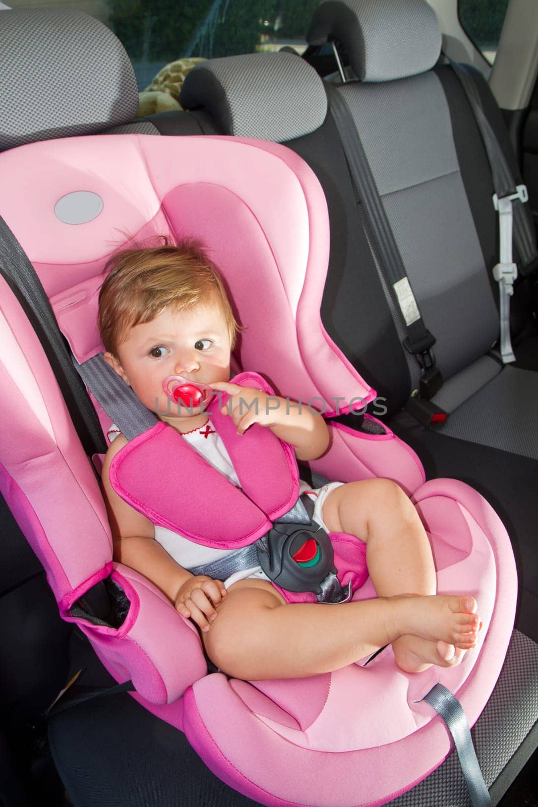 baby in a safety car seat. Safety and security