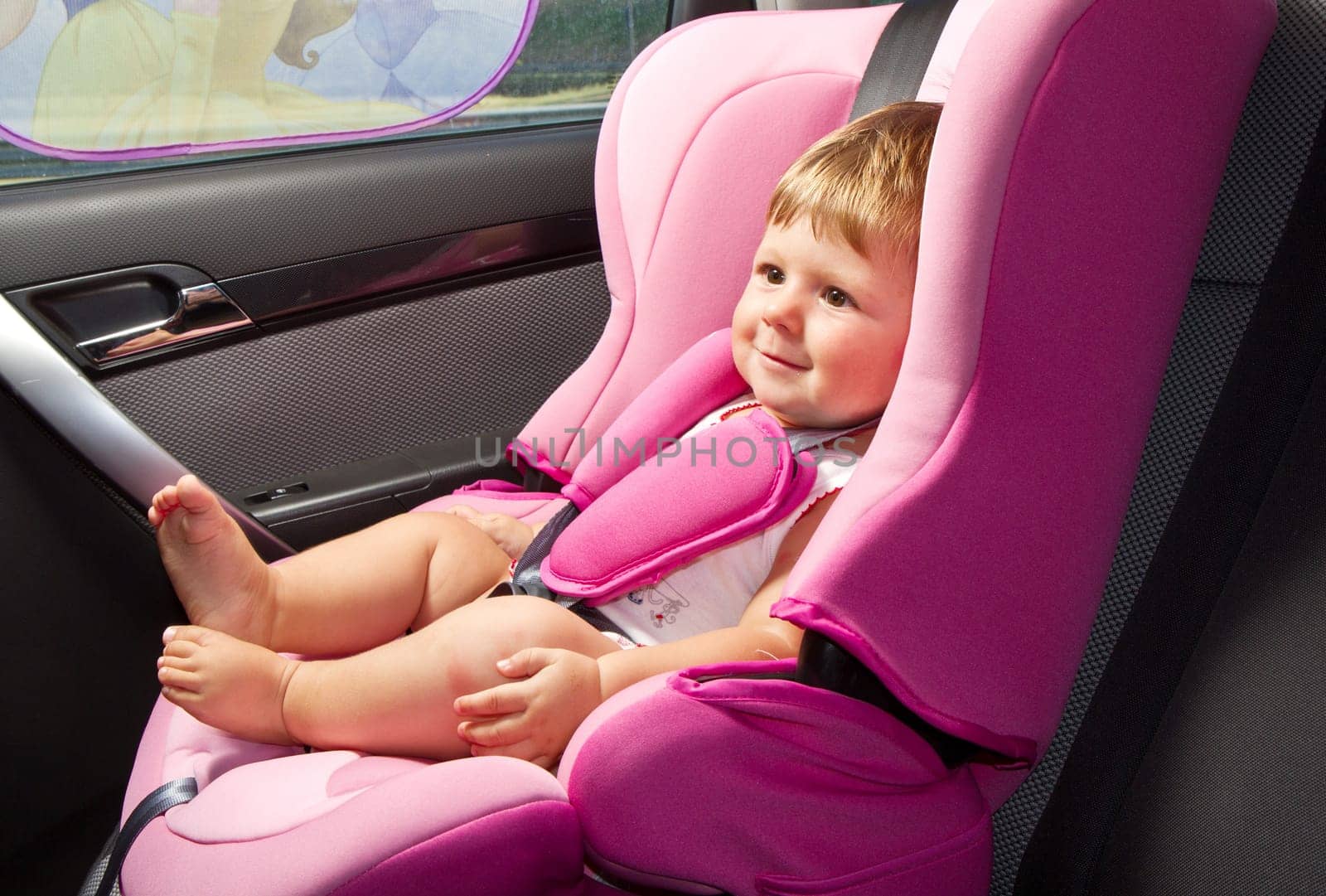 baby in a safety car seat. Safety and security