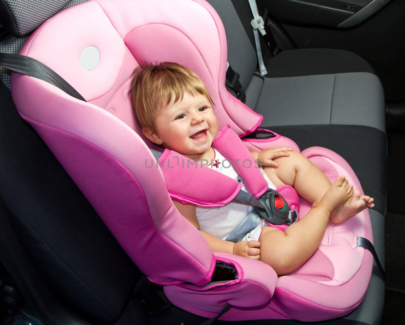 baby in a safety car seat. Safety and security