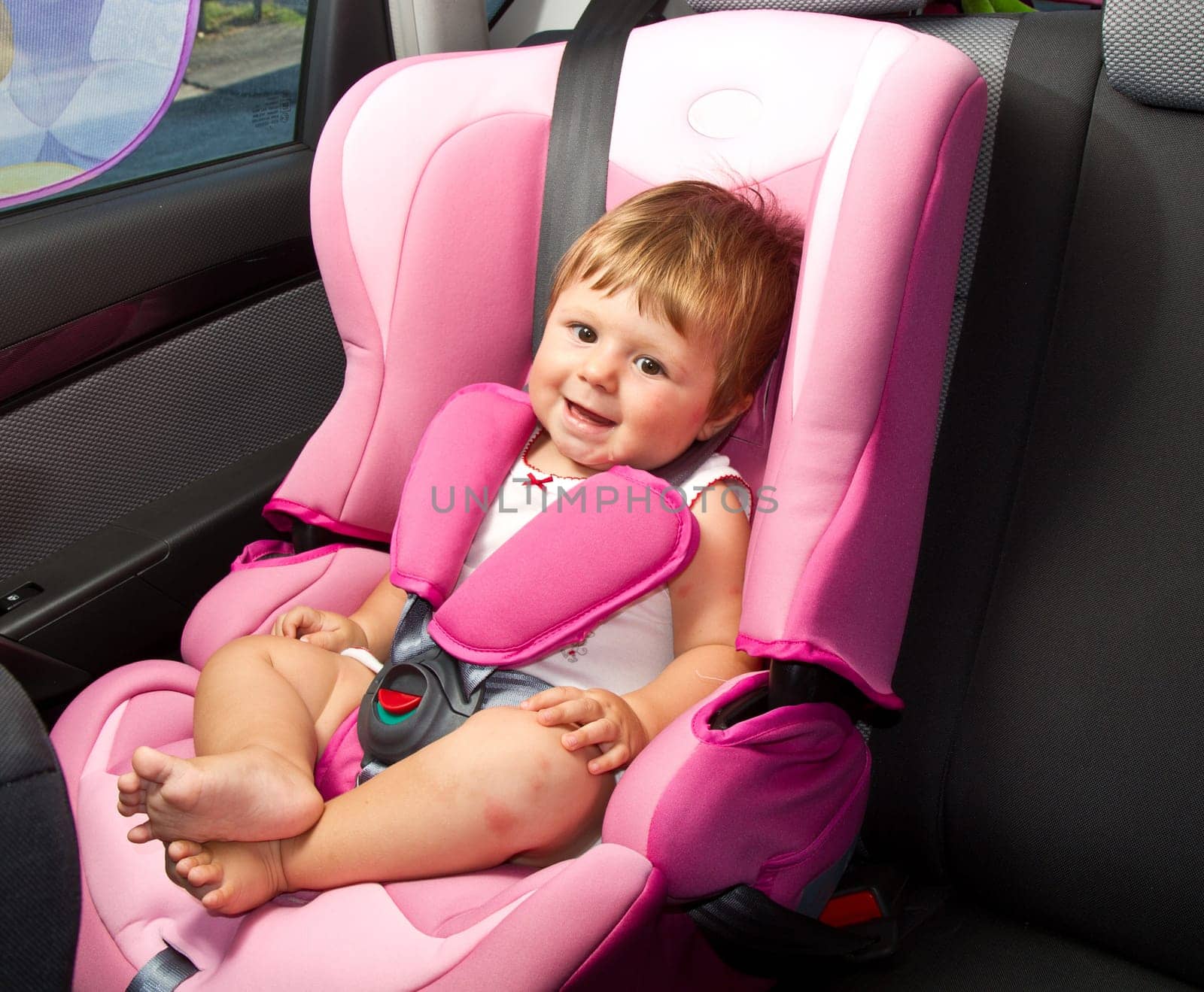 baby in a safety car seat. Safety and security