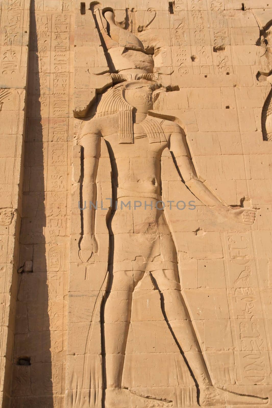 Carving of Egyptian god on pylon in Temple of Phylae near Aswan (Nubia, Egypt)