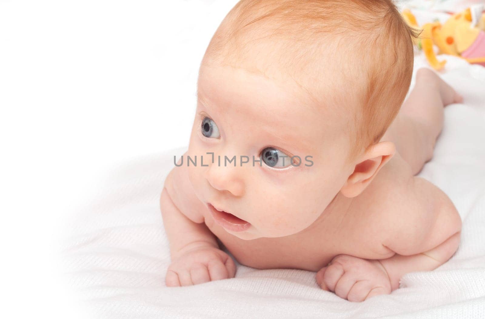 Cute Naked Red Haired Baby Lying on Front