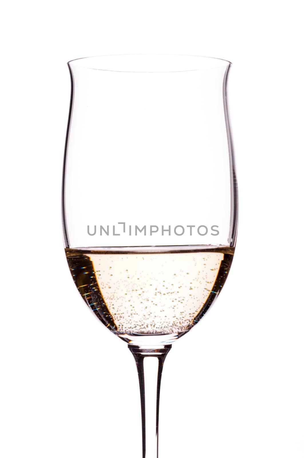 Carbonated white wine backlit in wine glass