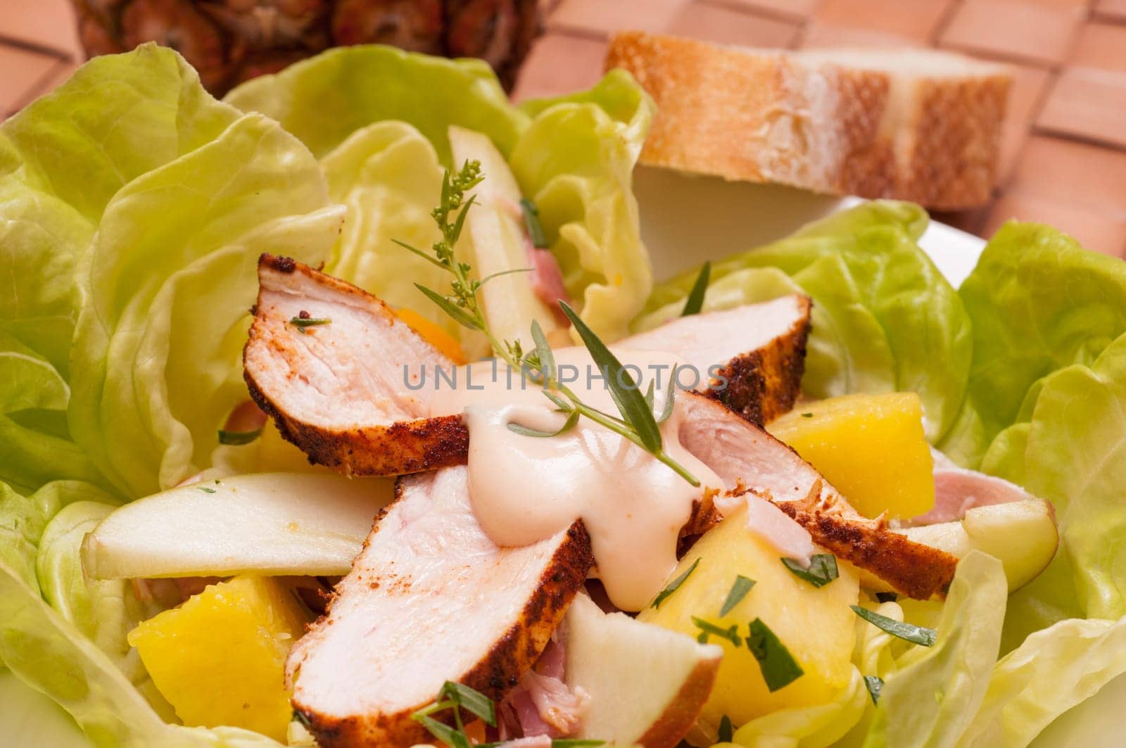 Chicken breast with fruit,dressing and tarragon in salad