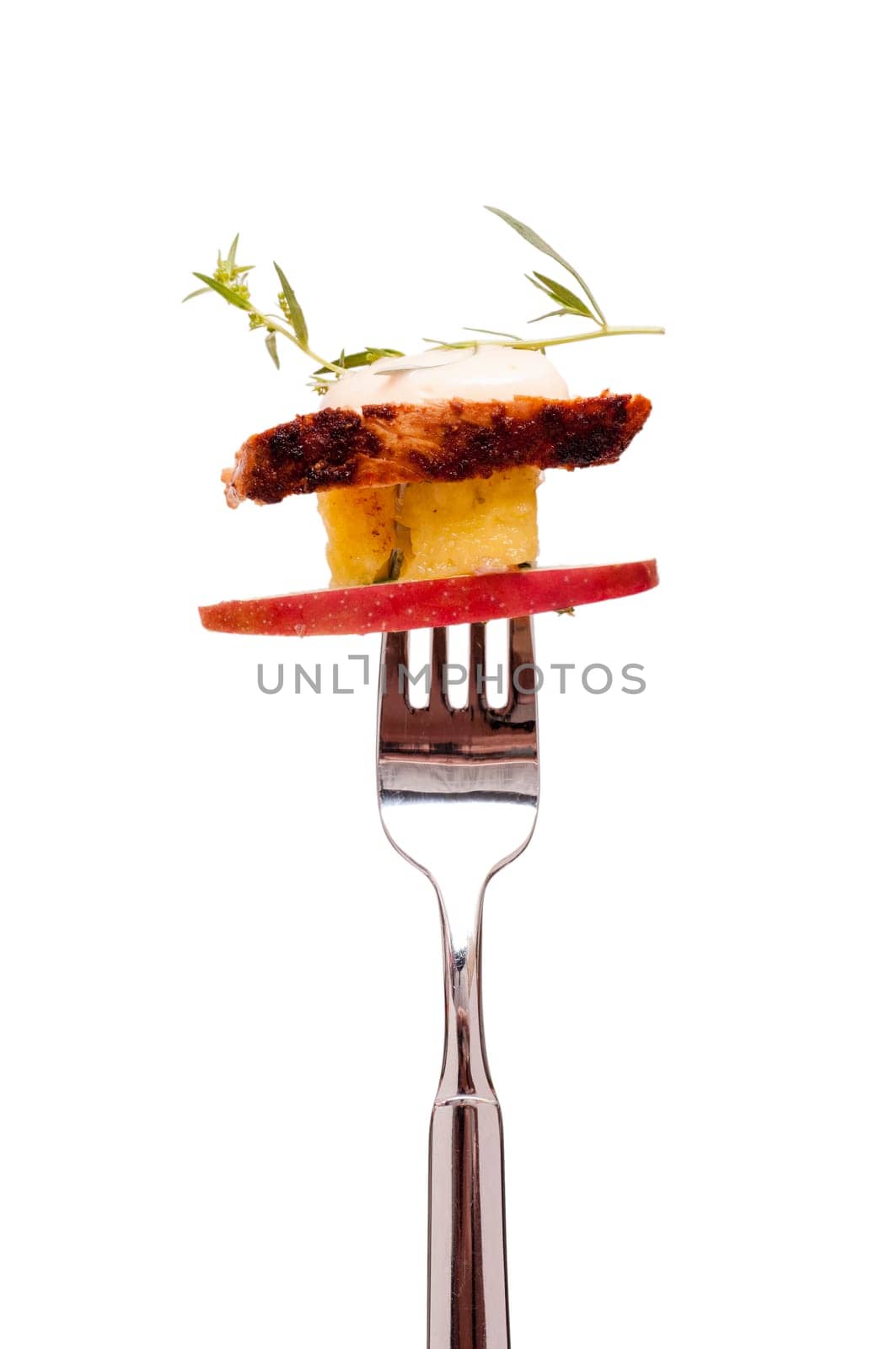 Isolated salad with chicken and fruit on a fork