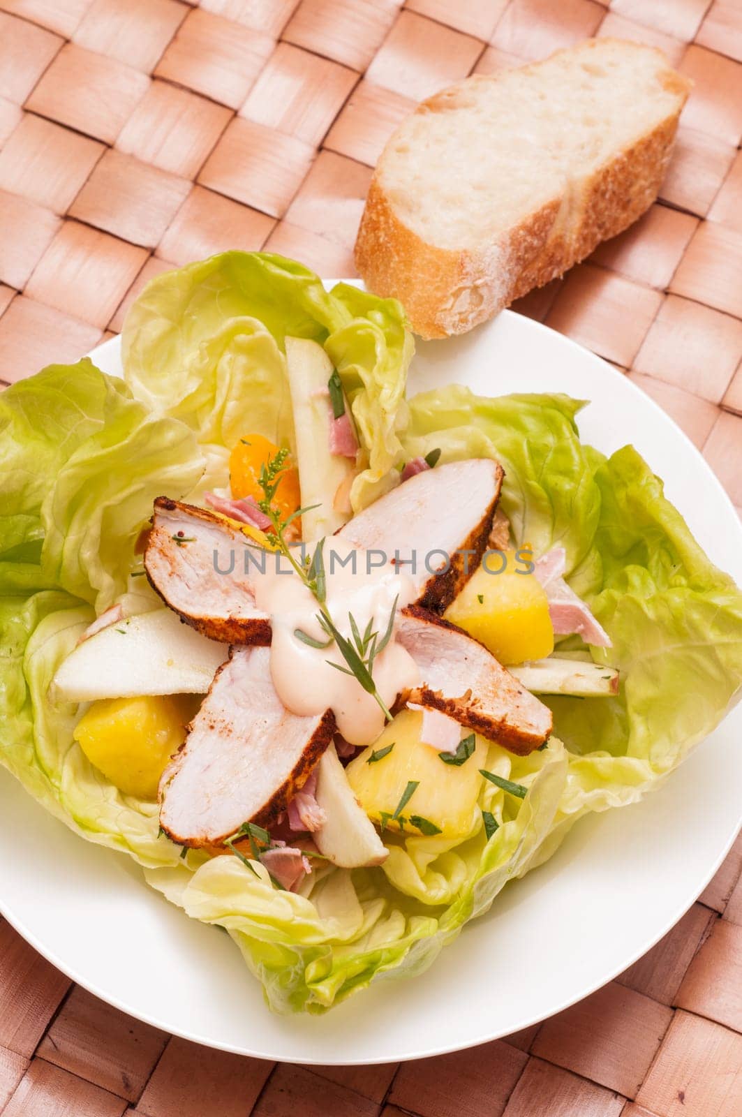 Swabian poultry salad with white bread on a plate