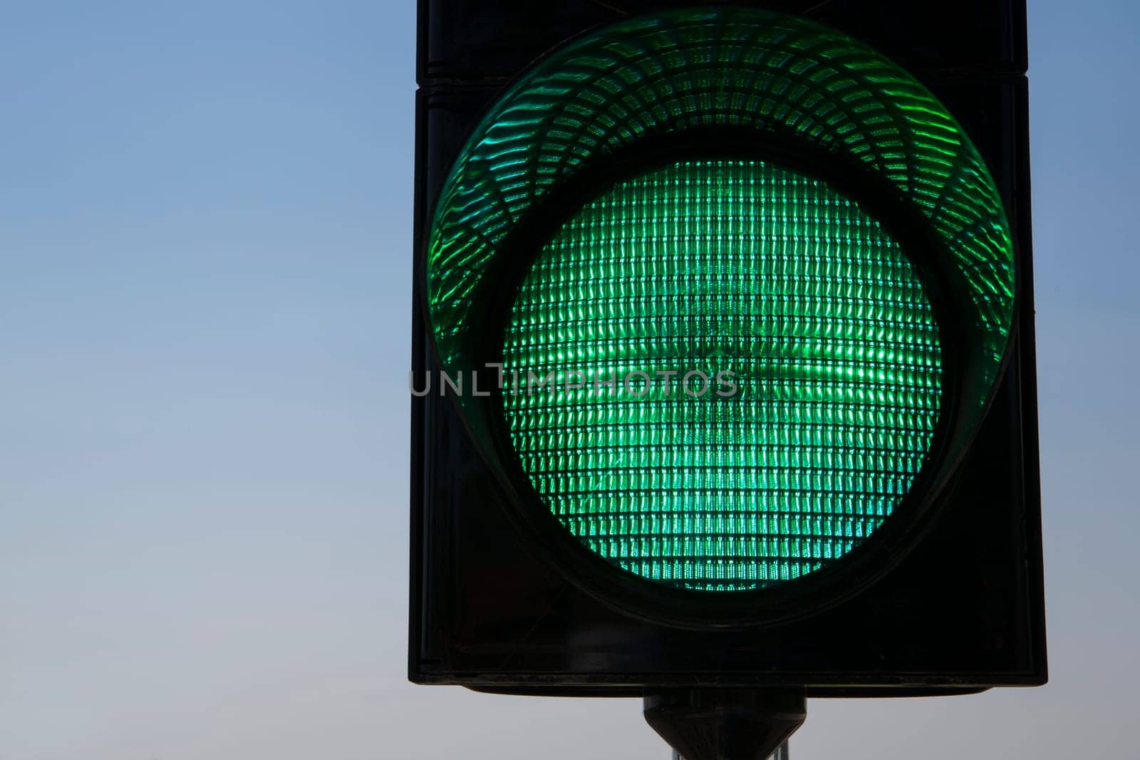 Shaded trafficlight which warning car drivers to stop
