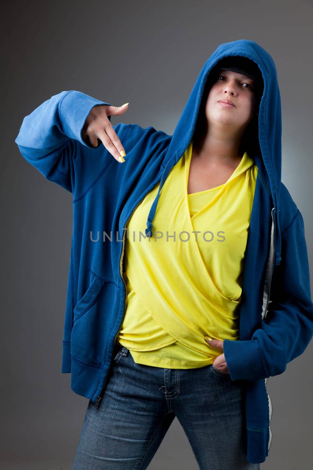 Studio portrait of a serious looking girl in a blue hooded jacket
