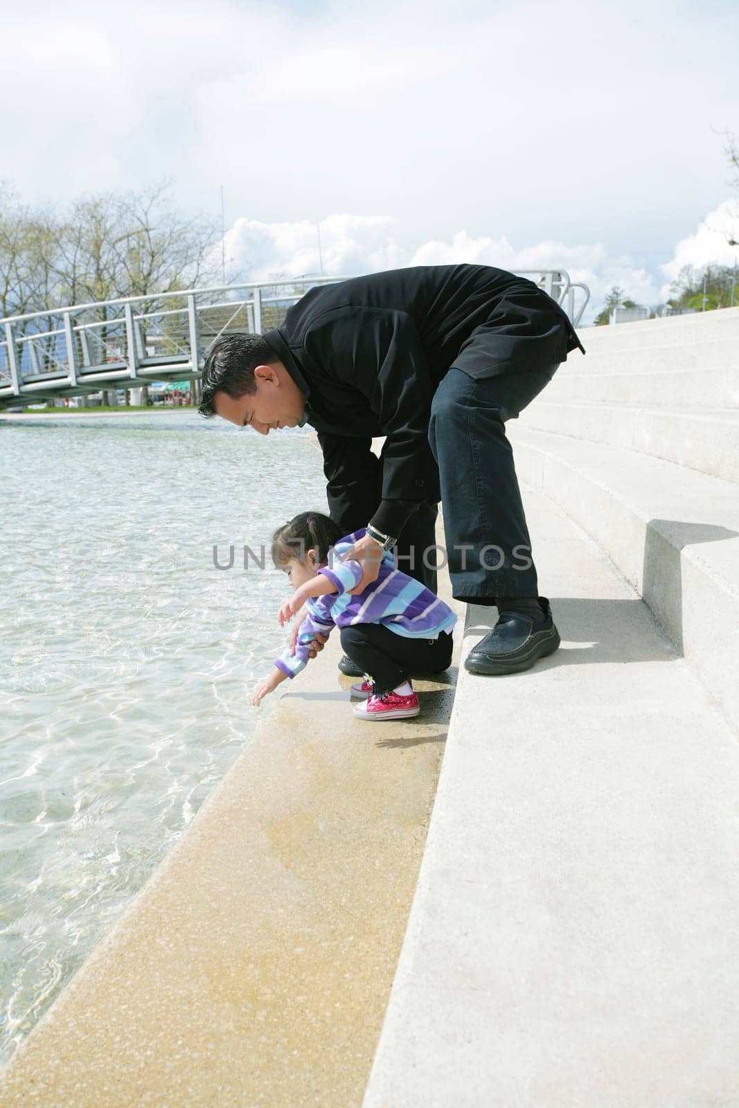 Father and daughter playing in the park at spring in Ouchy, Switzerland
