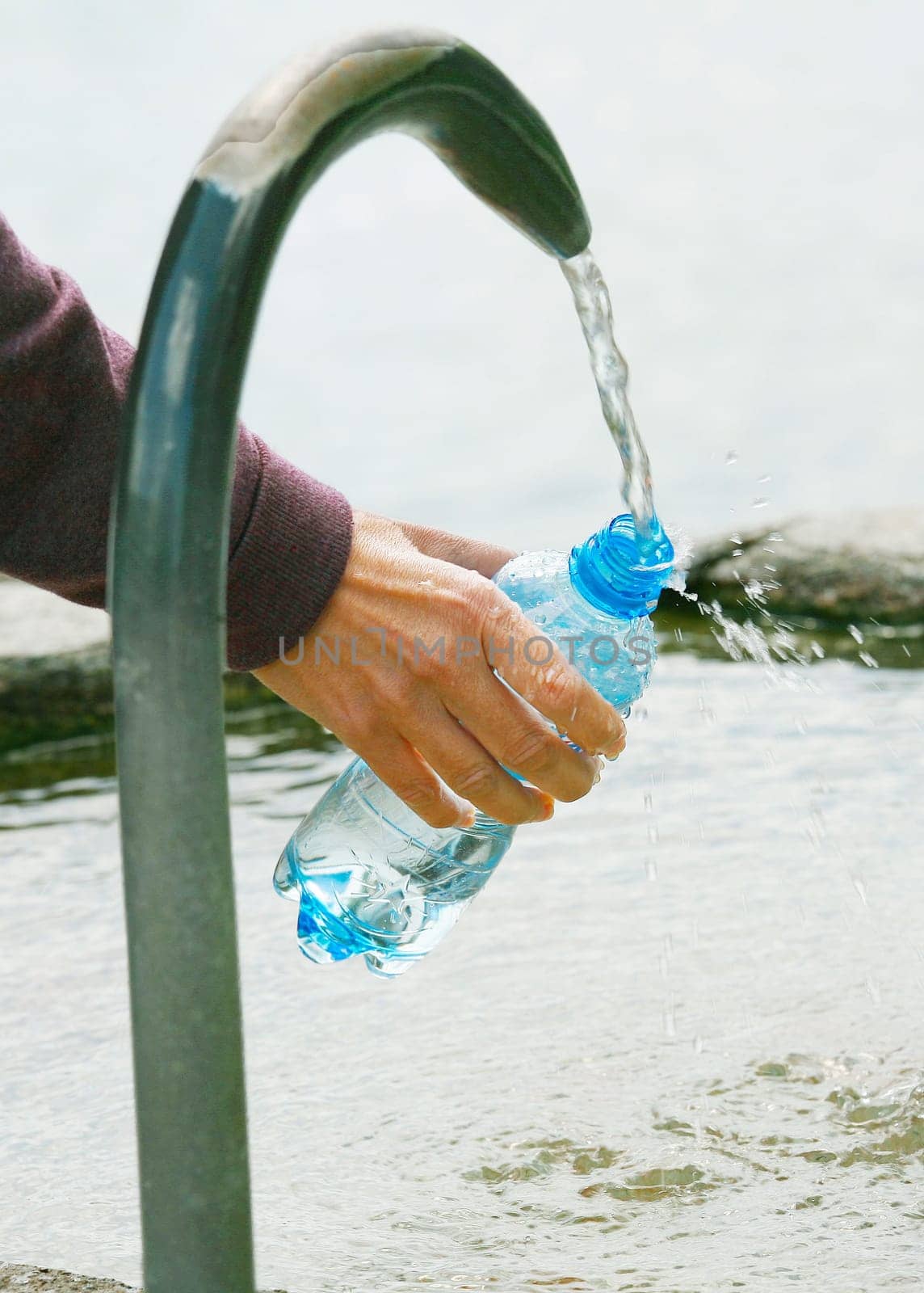 fountain of spring water bottle filling holding hand in Lugano, Switzerland