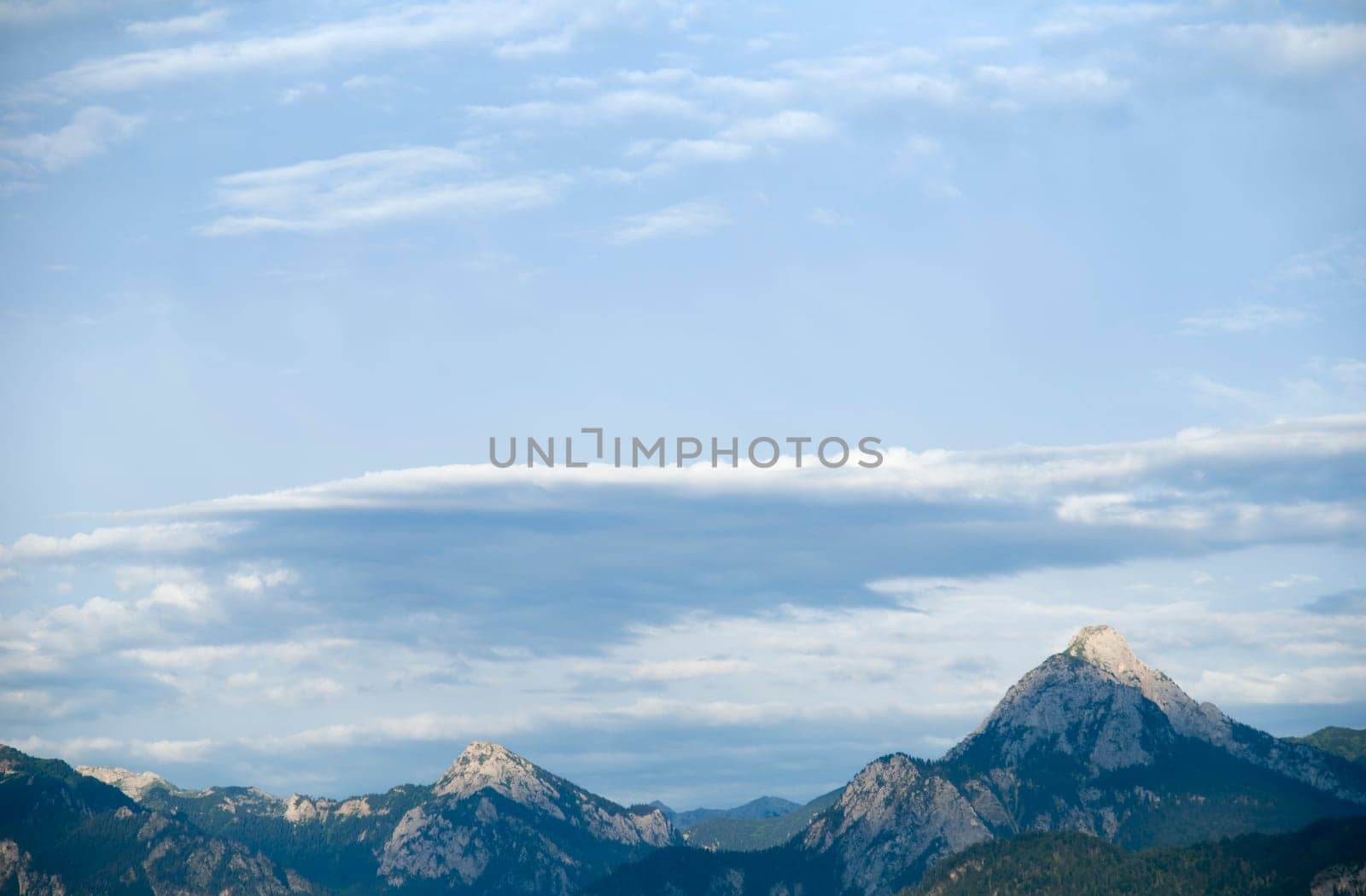 View of a mountain range in the Oberallgäu at dusk with light,clouds