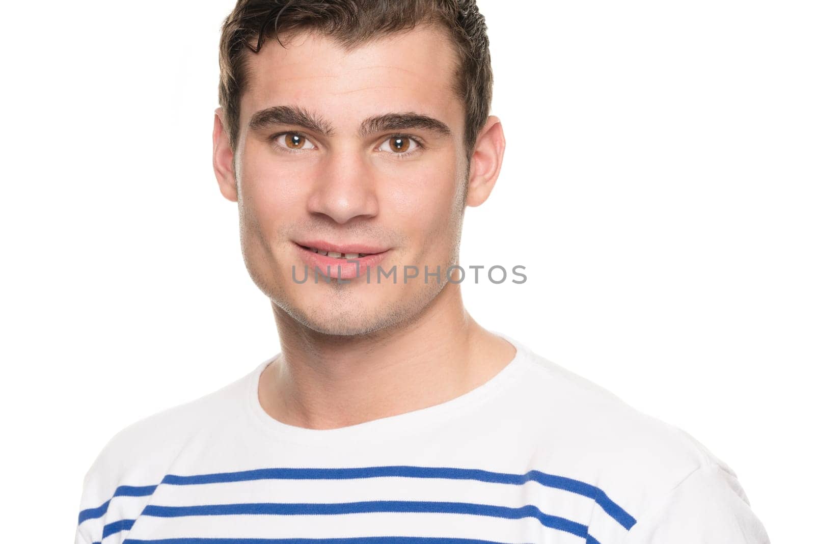 Portrait of a young man against a white studio background