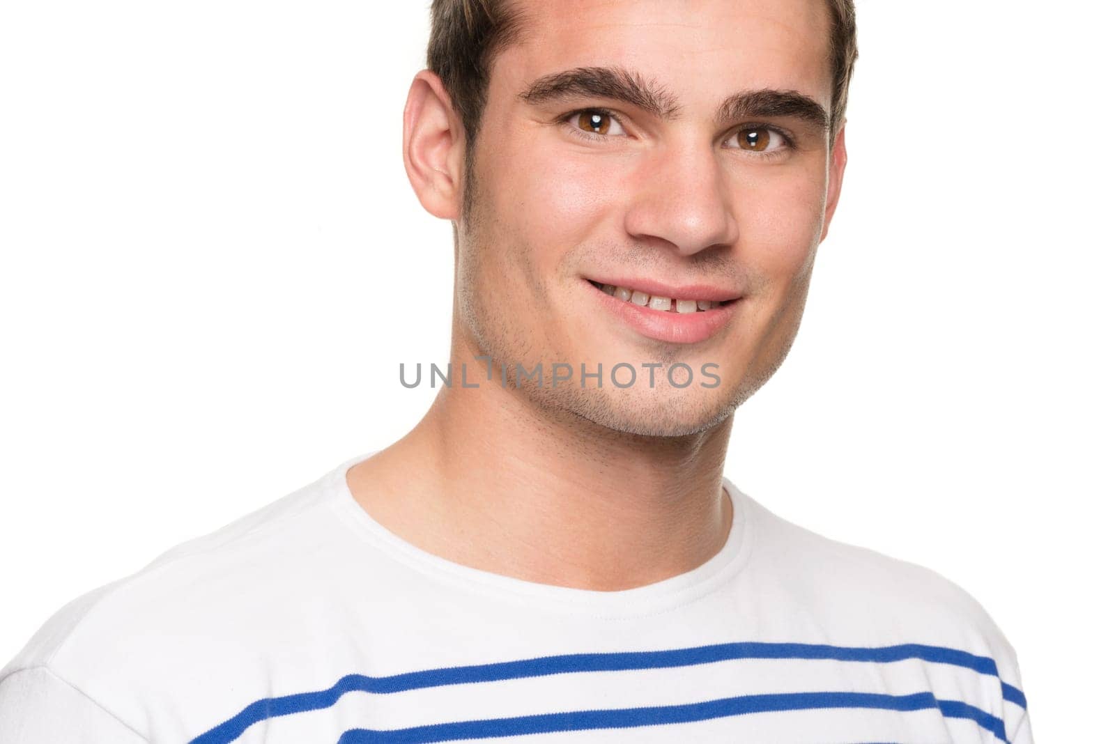 Portrait of a young man against a white studio background