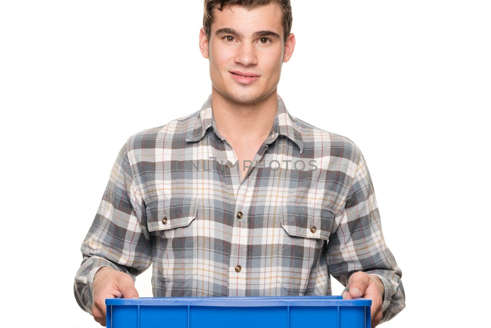Young man with a blue box against a white studio background