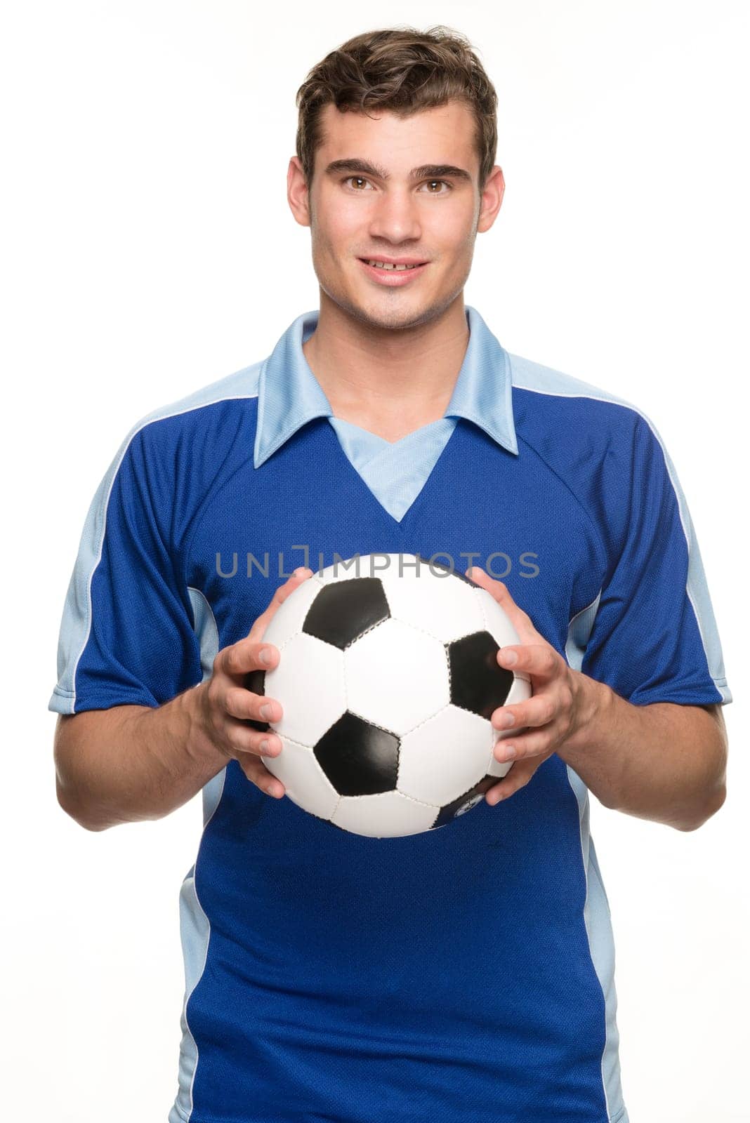 Young man with a soccer ball in front of white studio background