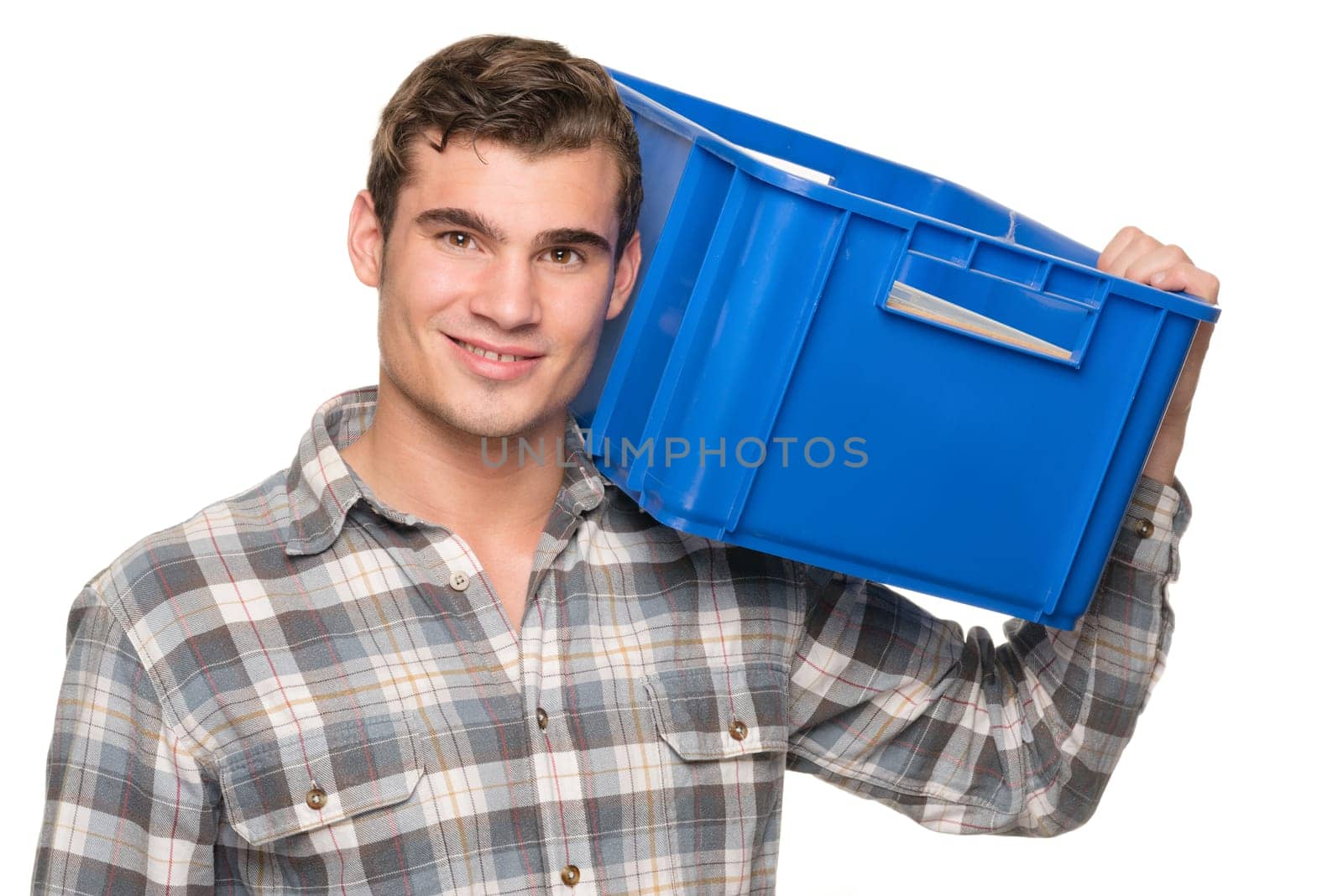 Young man with a blue box against a white studio background