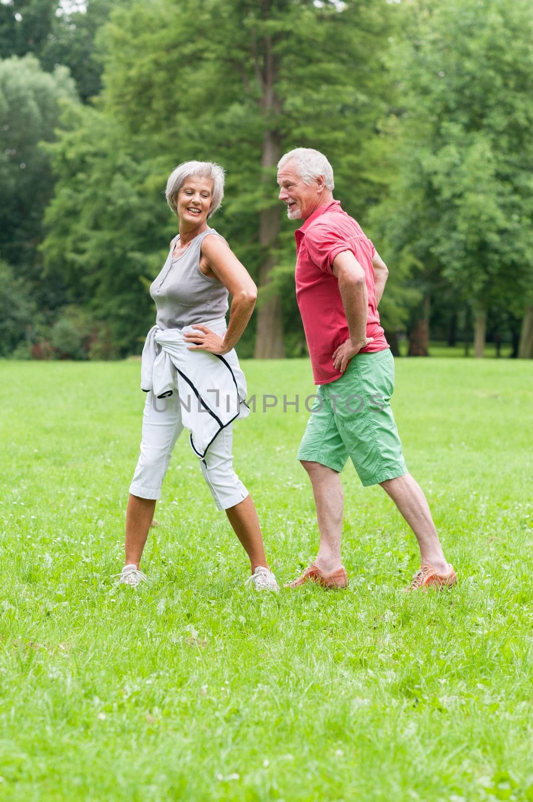 Active retired couple doing sports in a park