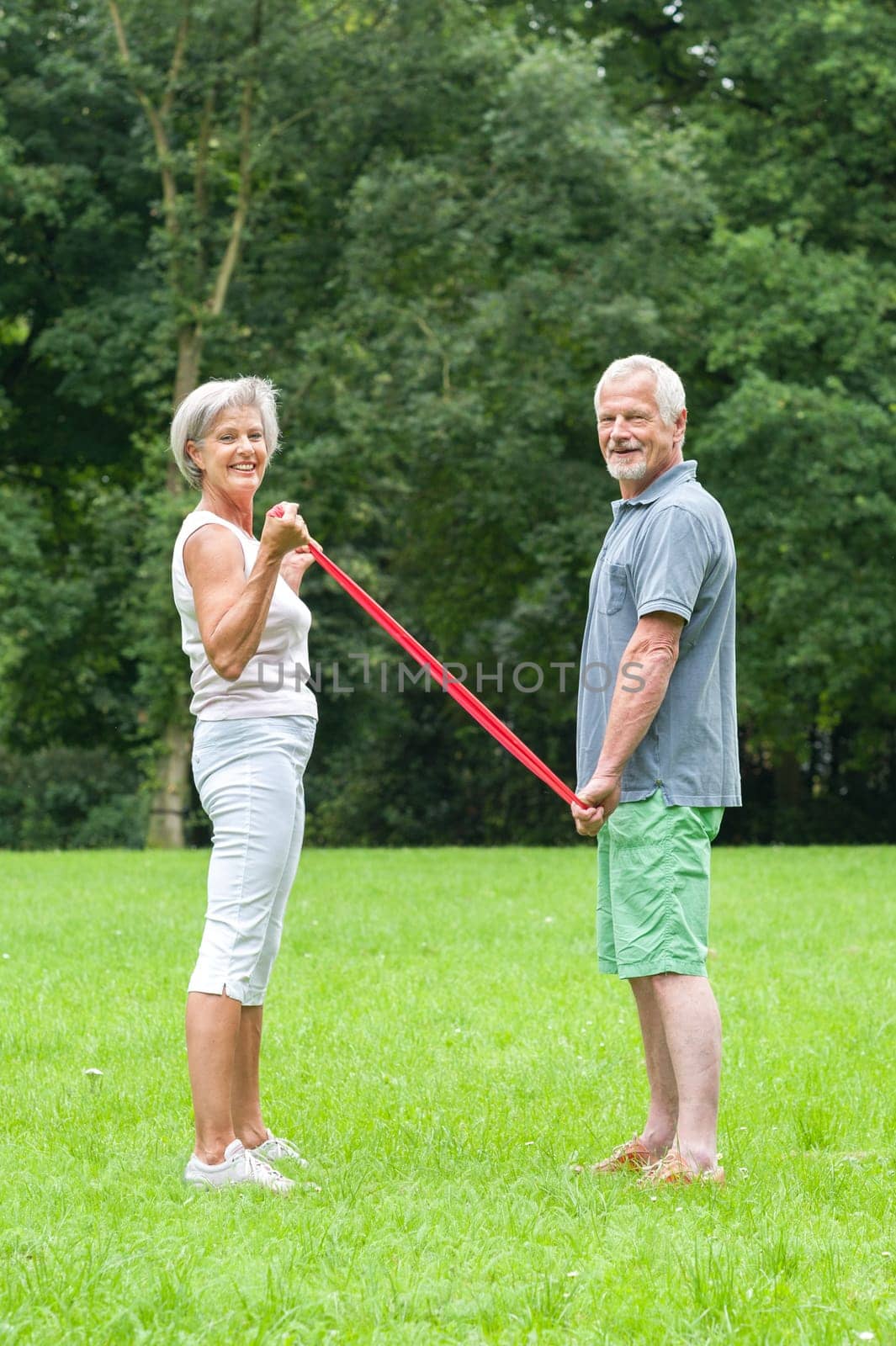 Active retired couple doing sports in a park