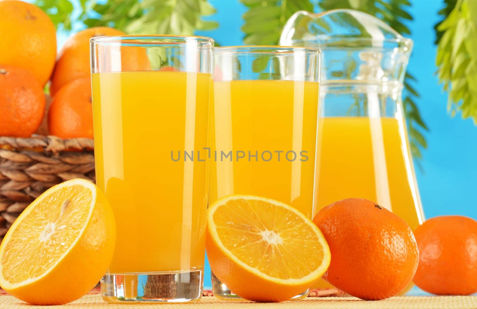 Composition with two glasses of orange juice and fruits