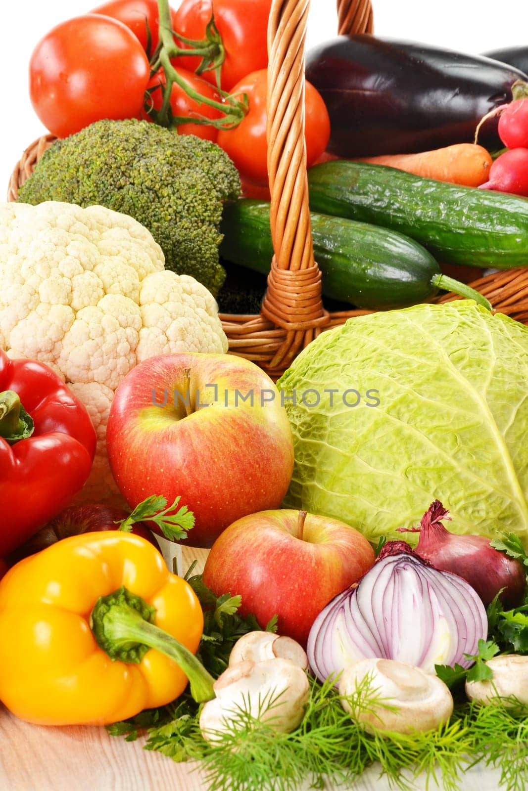 Composition with wicker basket and grocery isolated on white