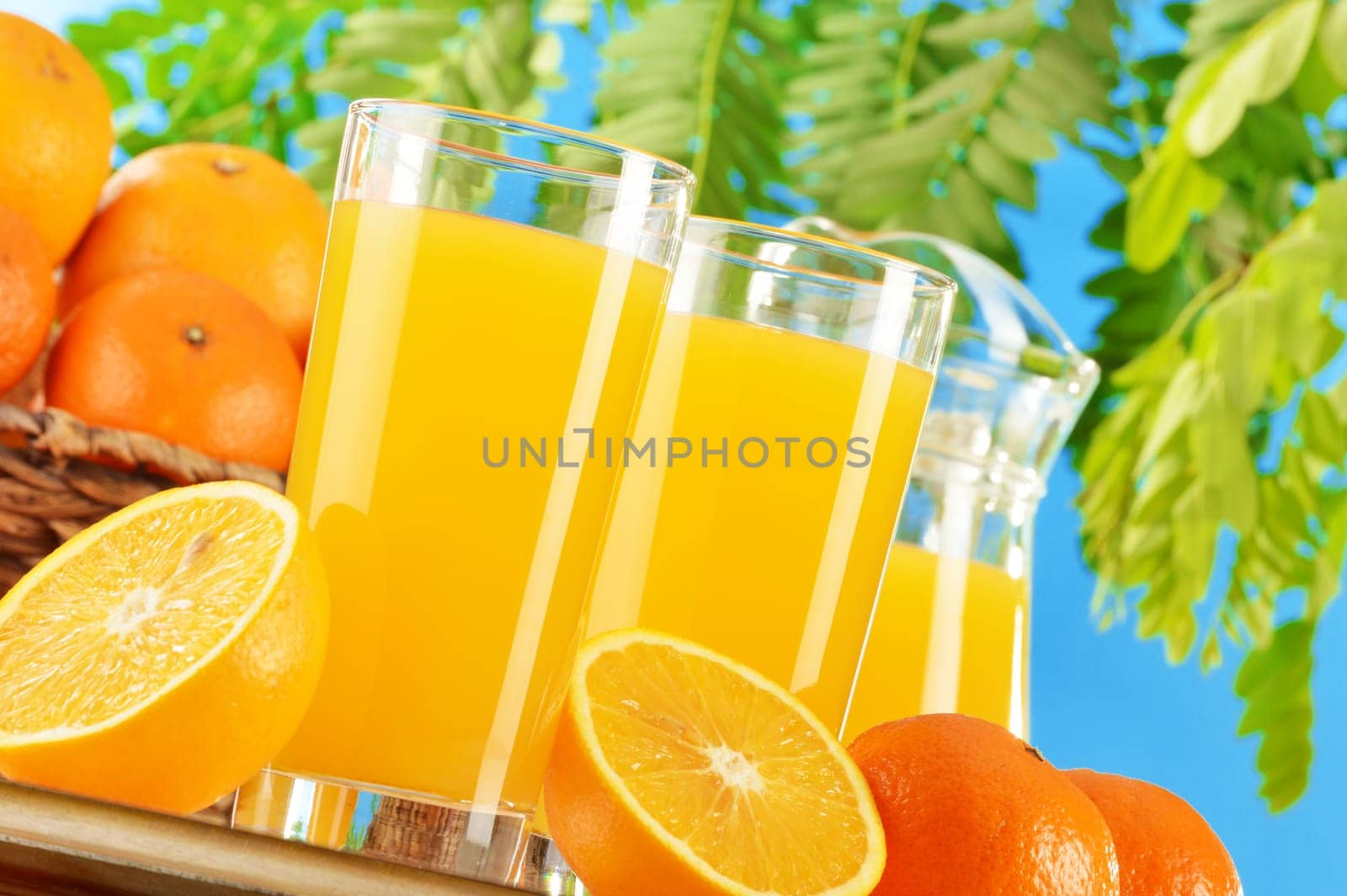 Composition with two glasses of orange juice and fruits