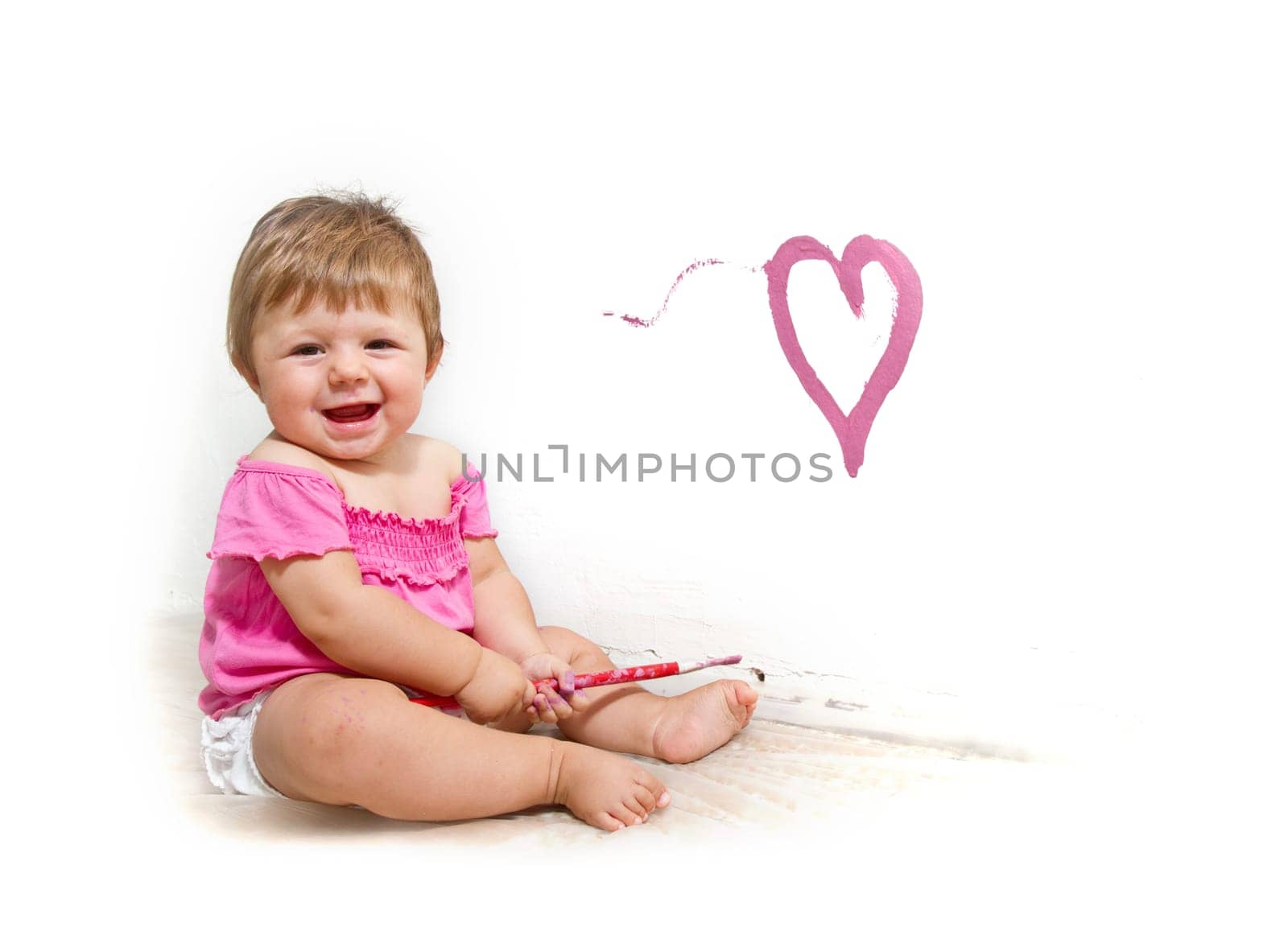 Little girl paint on a board