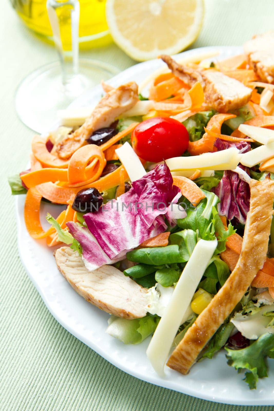 Chicken salad with fresh ingredients in the white bowl