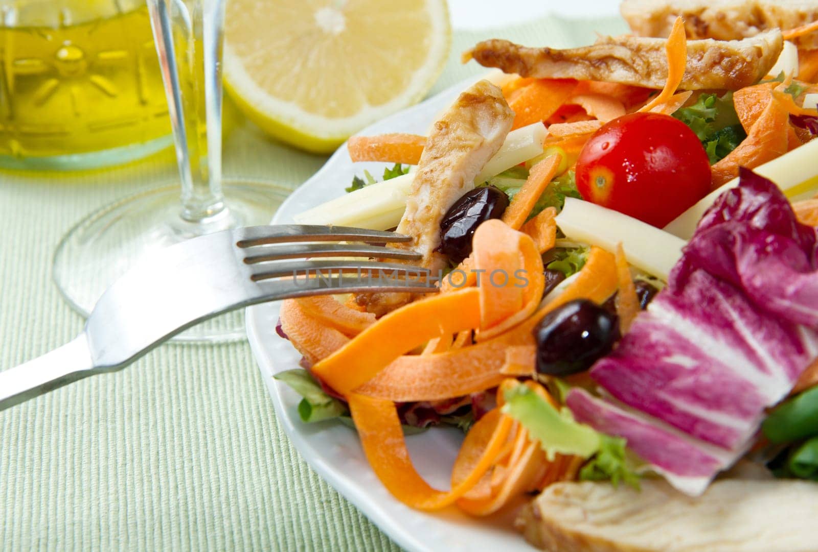 Chicken salad with fresh ingredients in the white bowl