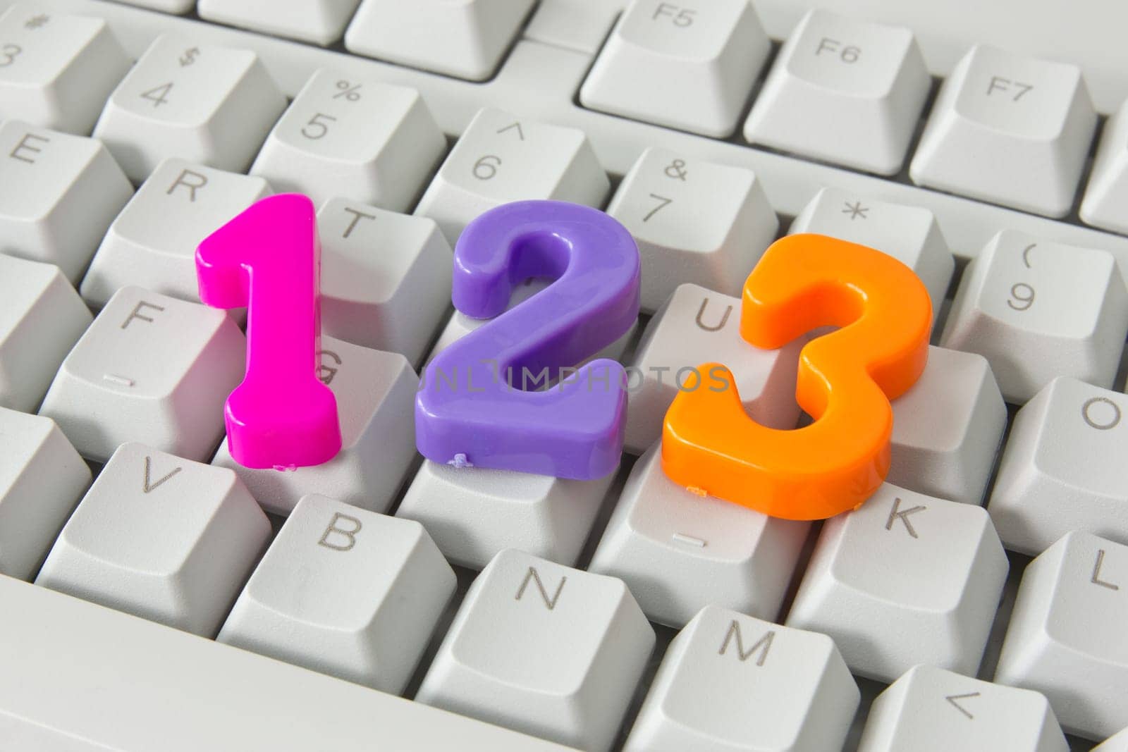 three color plastic numbers on the computer keyboard