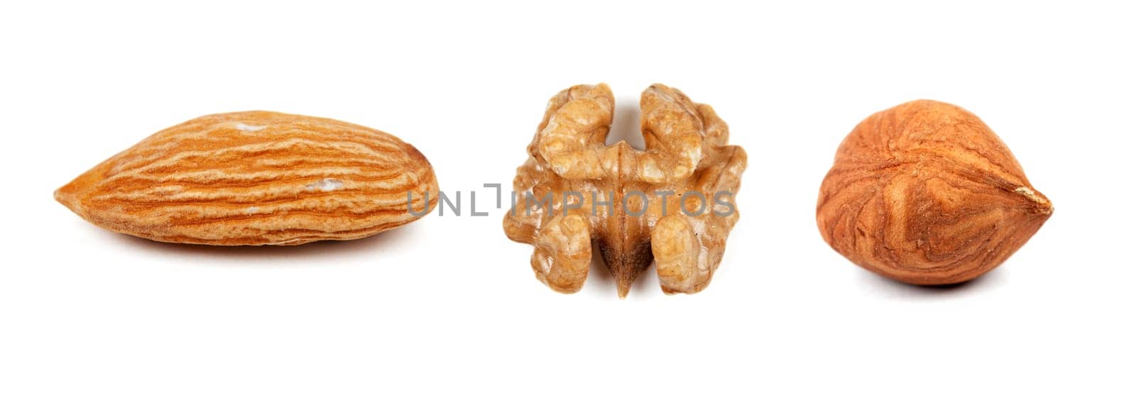 Collage of the three nuts, walnuts, hazelnuts, almonds, isolated on a white background. The image is composed of multiple photos