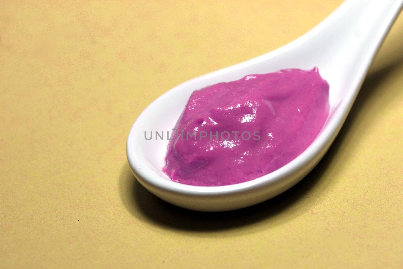 poisoned colored spice on a porcelain spoon