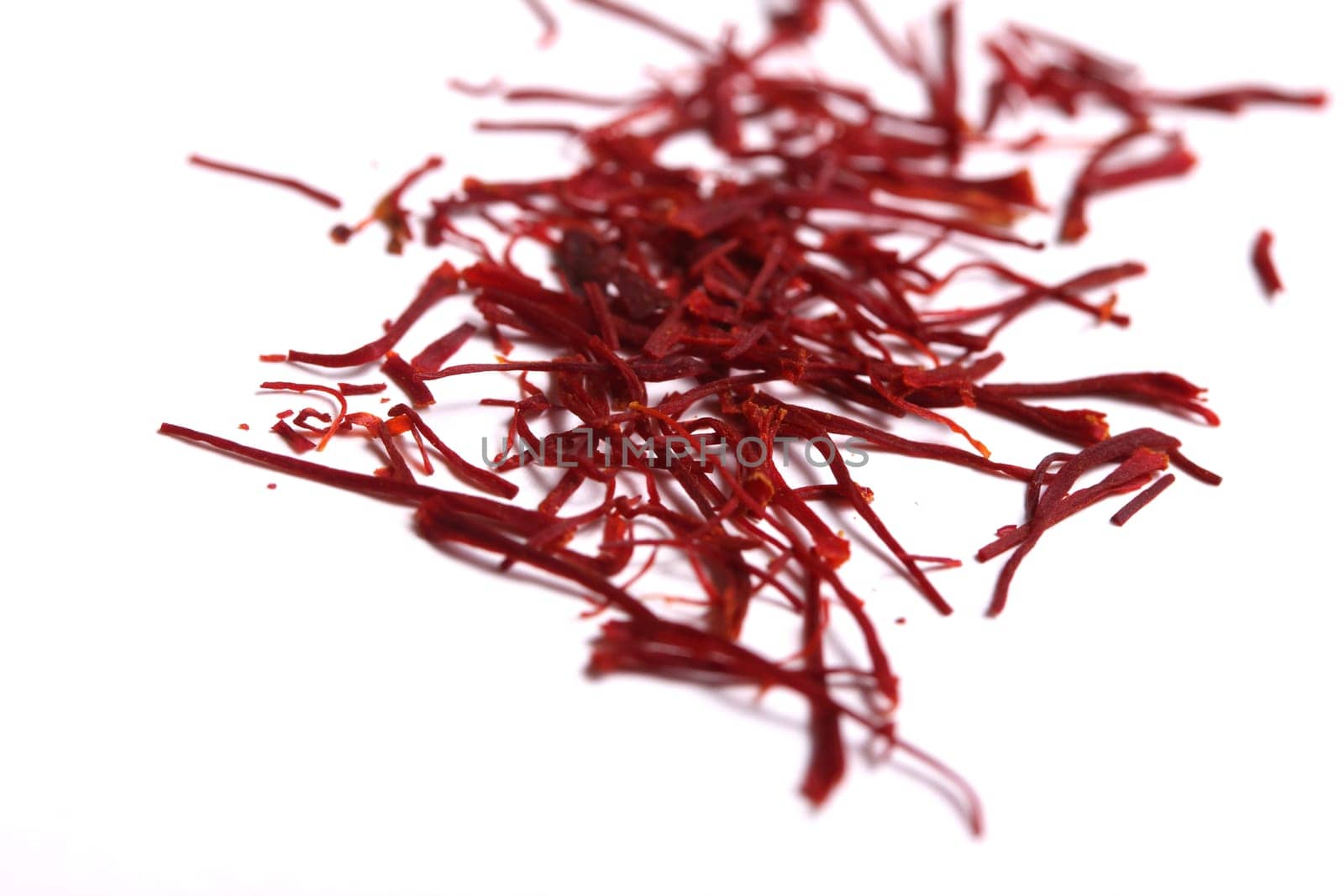 saffron threads in a red beverage