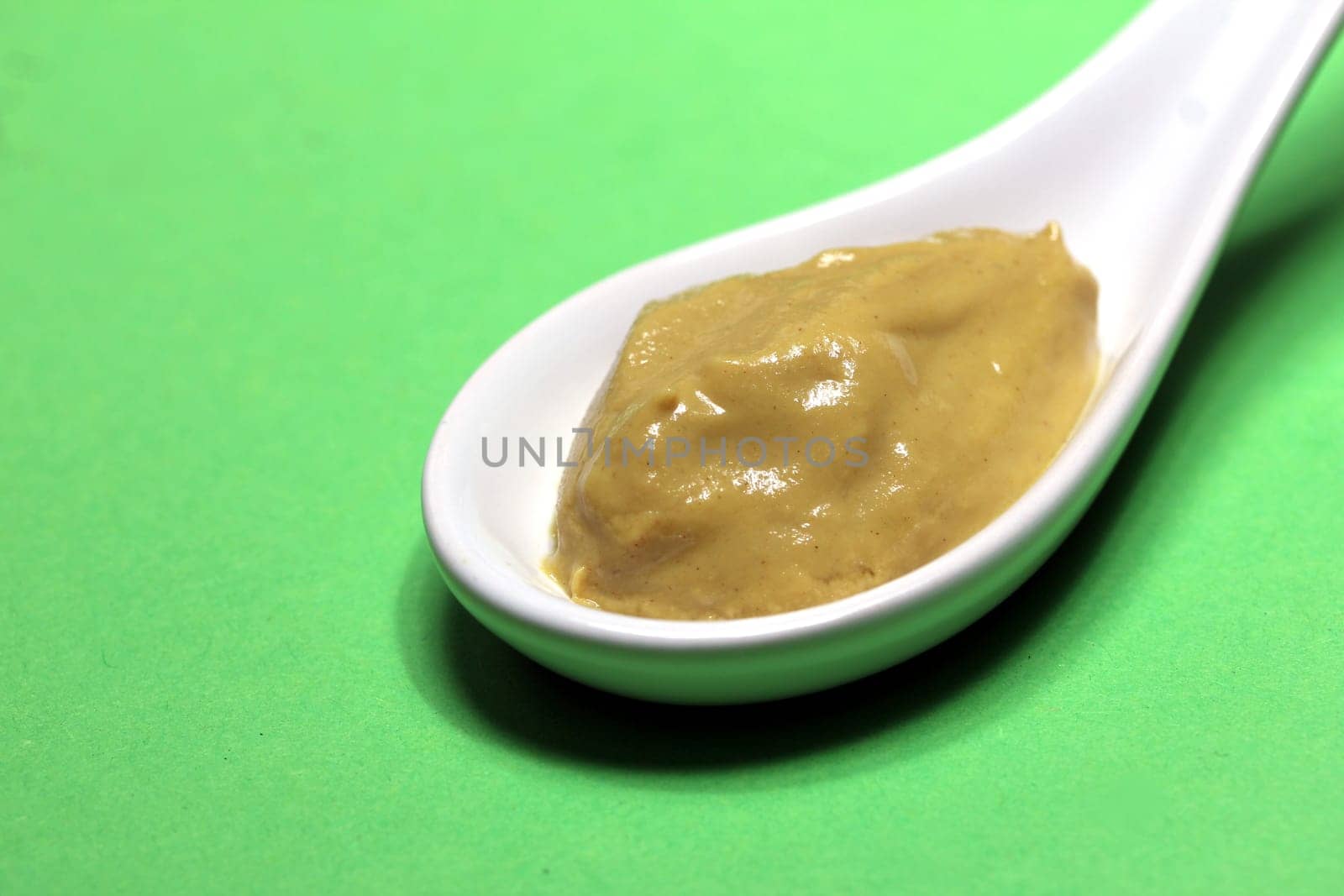 mustard on a porcelain spoon
