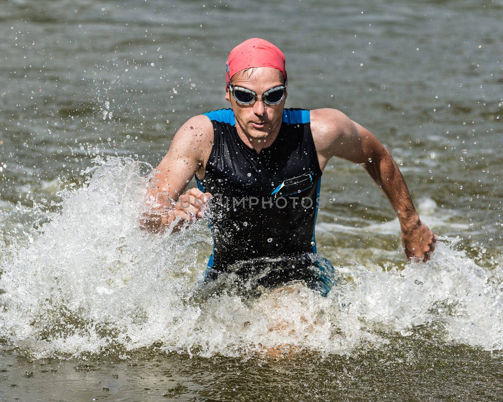 Triathlete runs out of the water