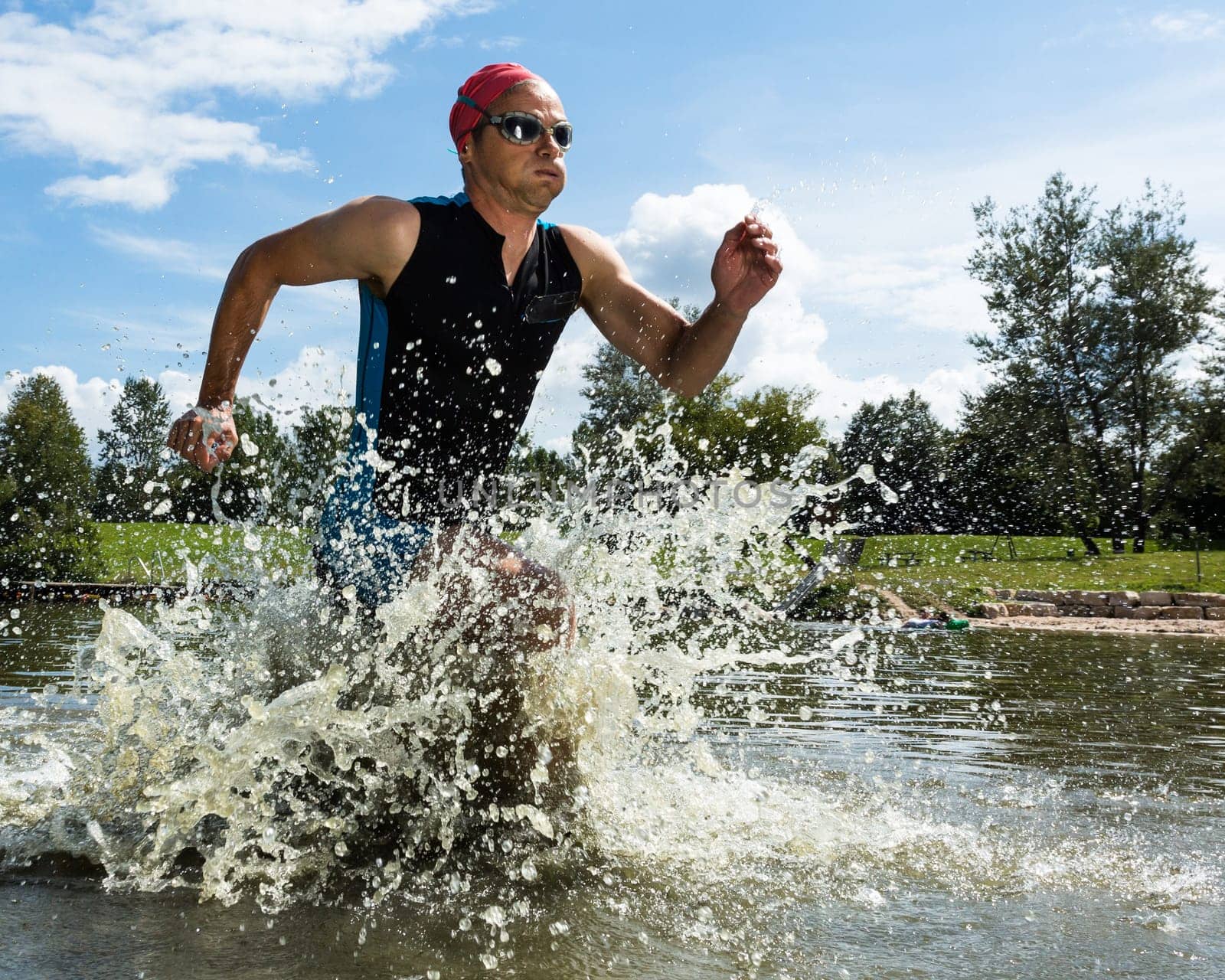 Triathlete runs out of the water