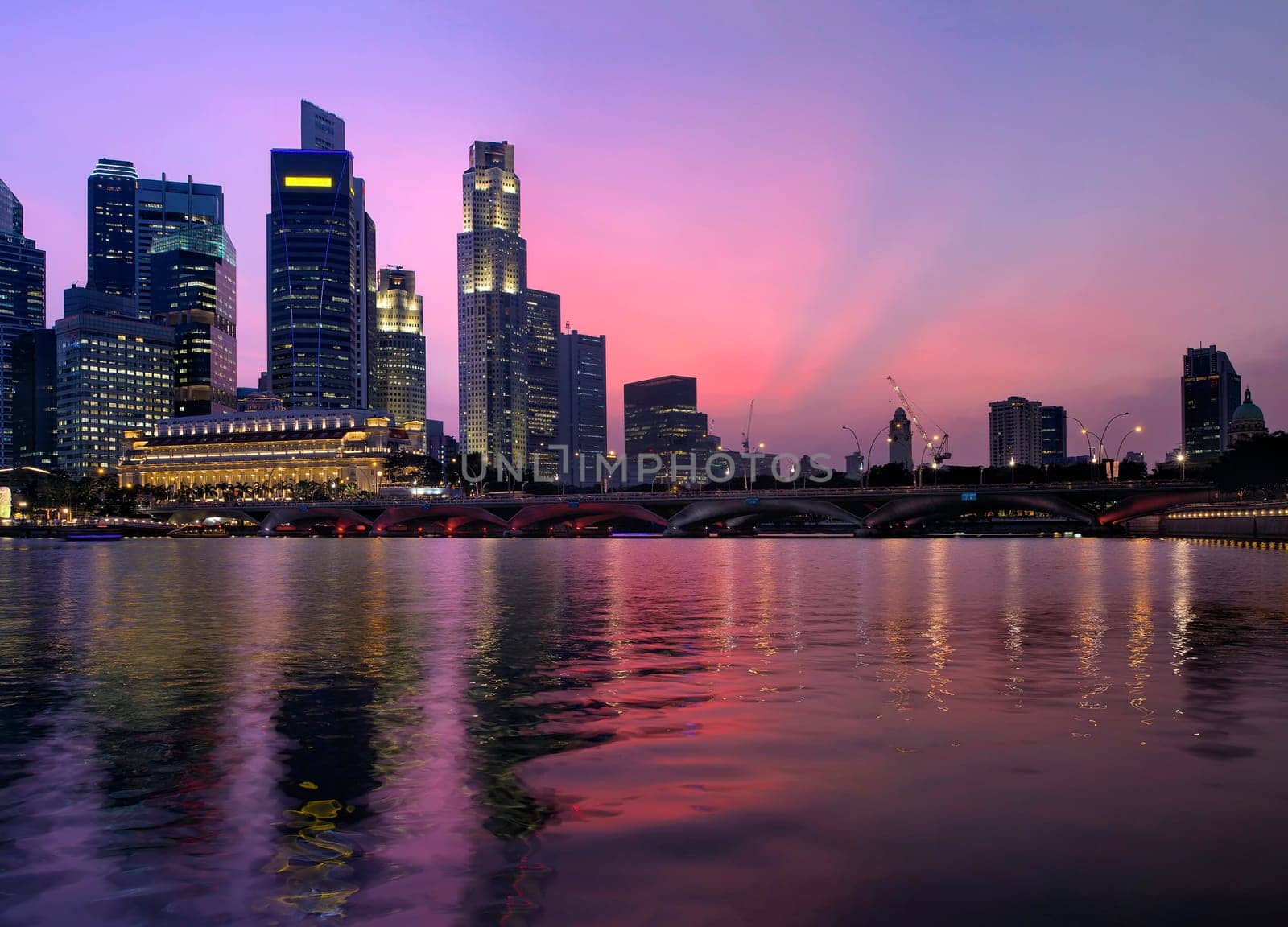 Singapore Central Business District Skyline Along River and Esplanade Bridge at Twilight