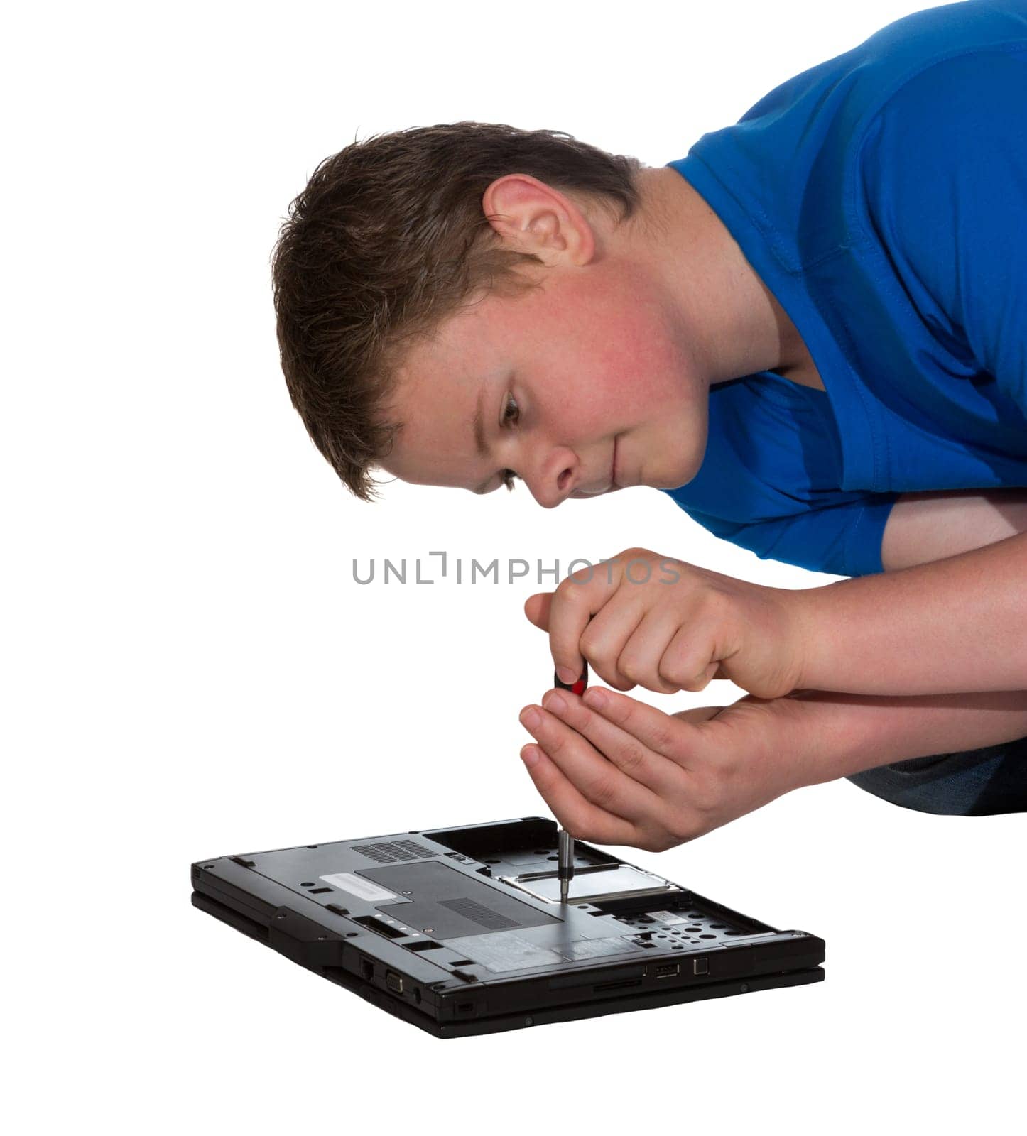 Man leaning over the bottom of his opened laptop doing home repairs or upgrades to hardware
