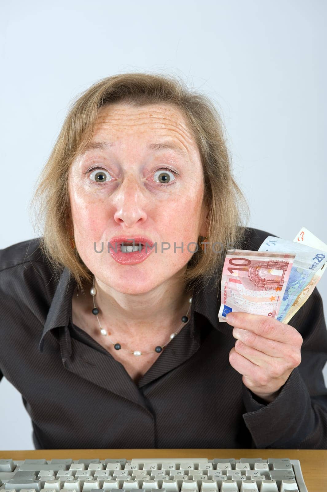 angry woman with money in the office