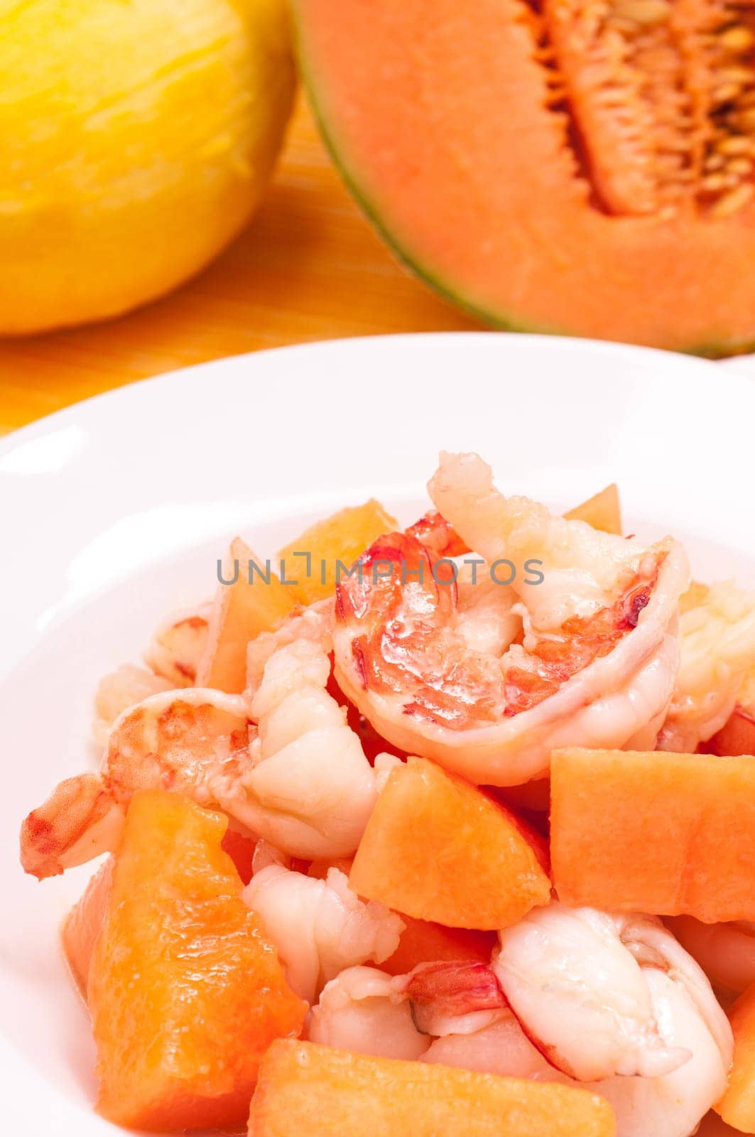 Plate of scampi with melon in portrait format