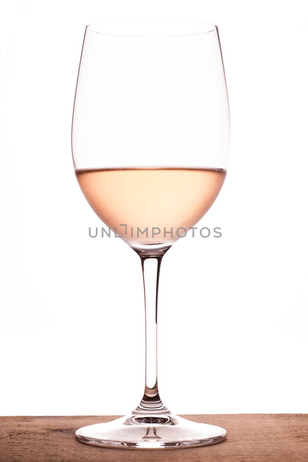 Rosé wine in a wine glass and backlight