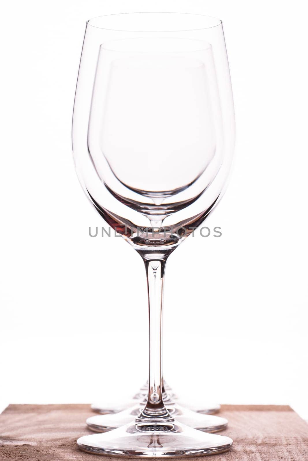Three wine glasses in a row backlit