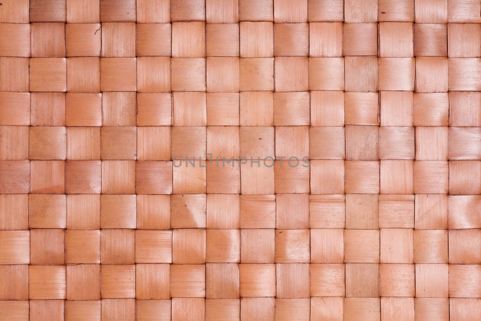 Brown background of braided dried palm leaves