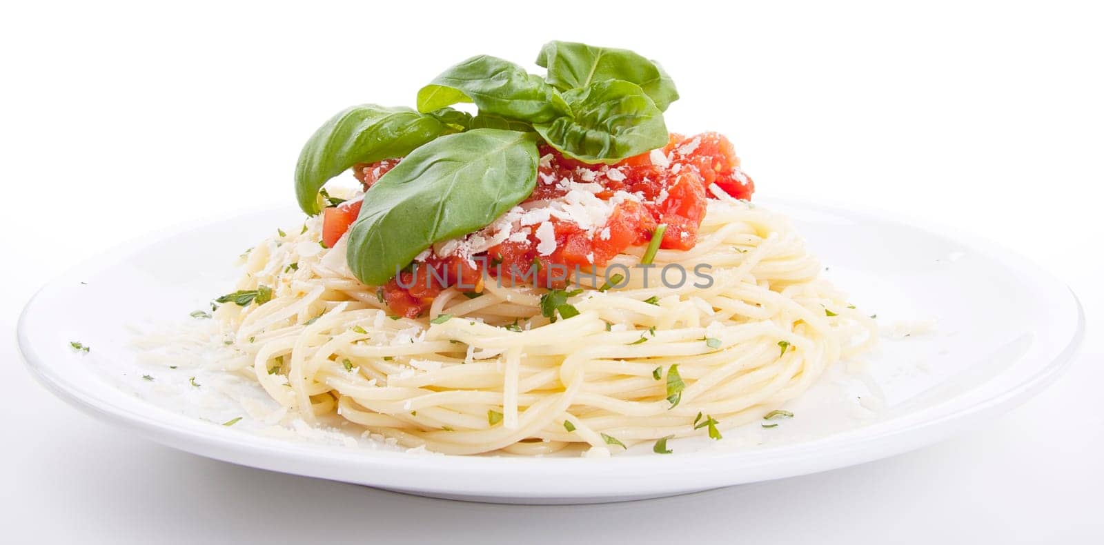 fresh delicious spaghetti with tomato sauce basil and parmesan isolated on white background