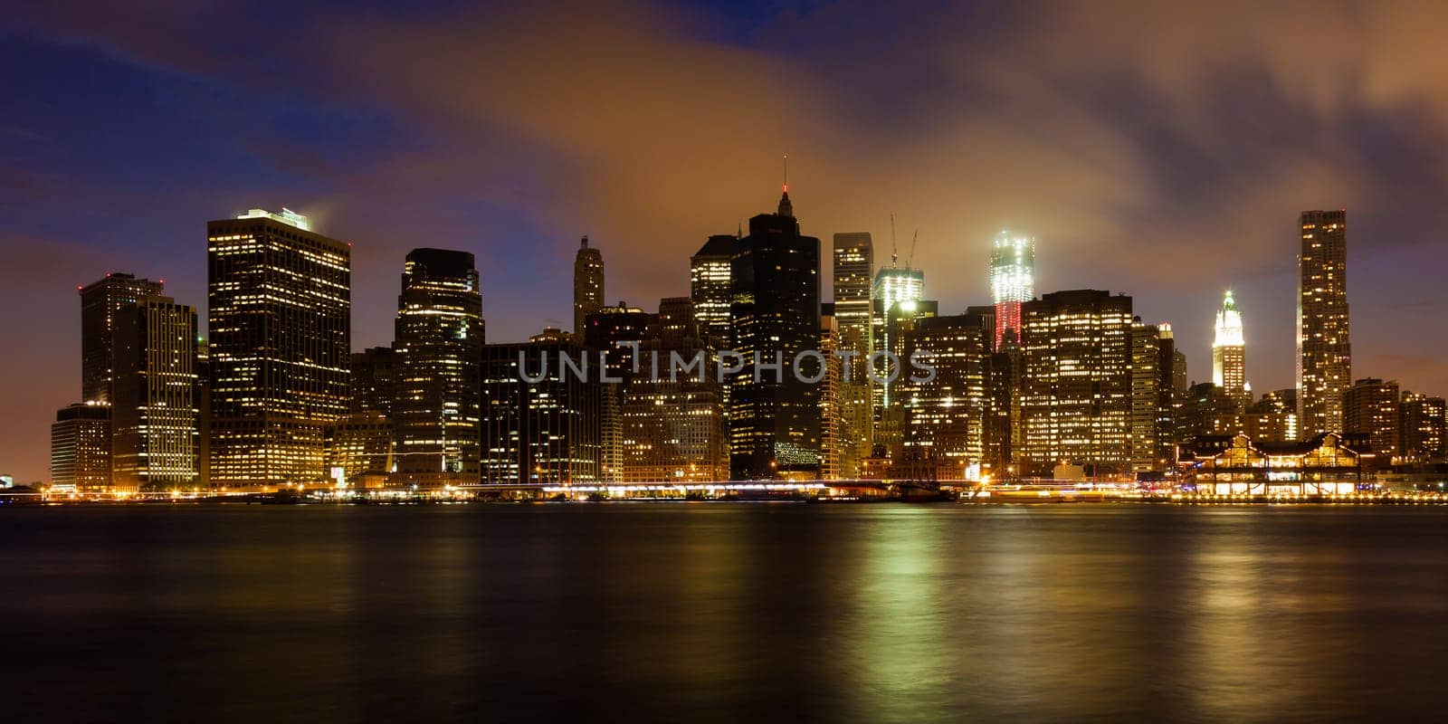 Manhattan skyline by night from Brooklyn bridge park - USA