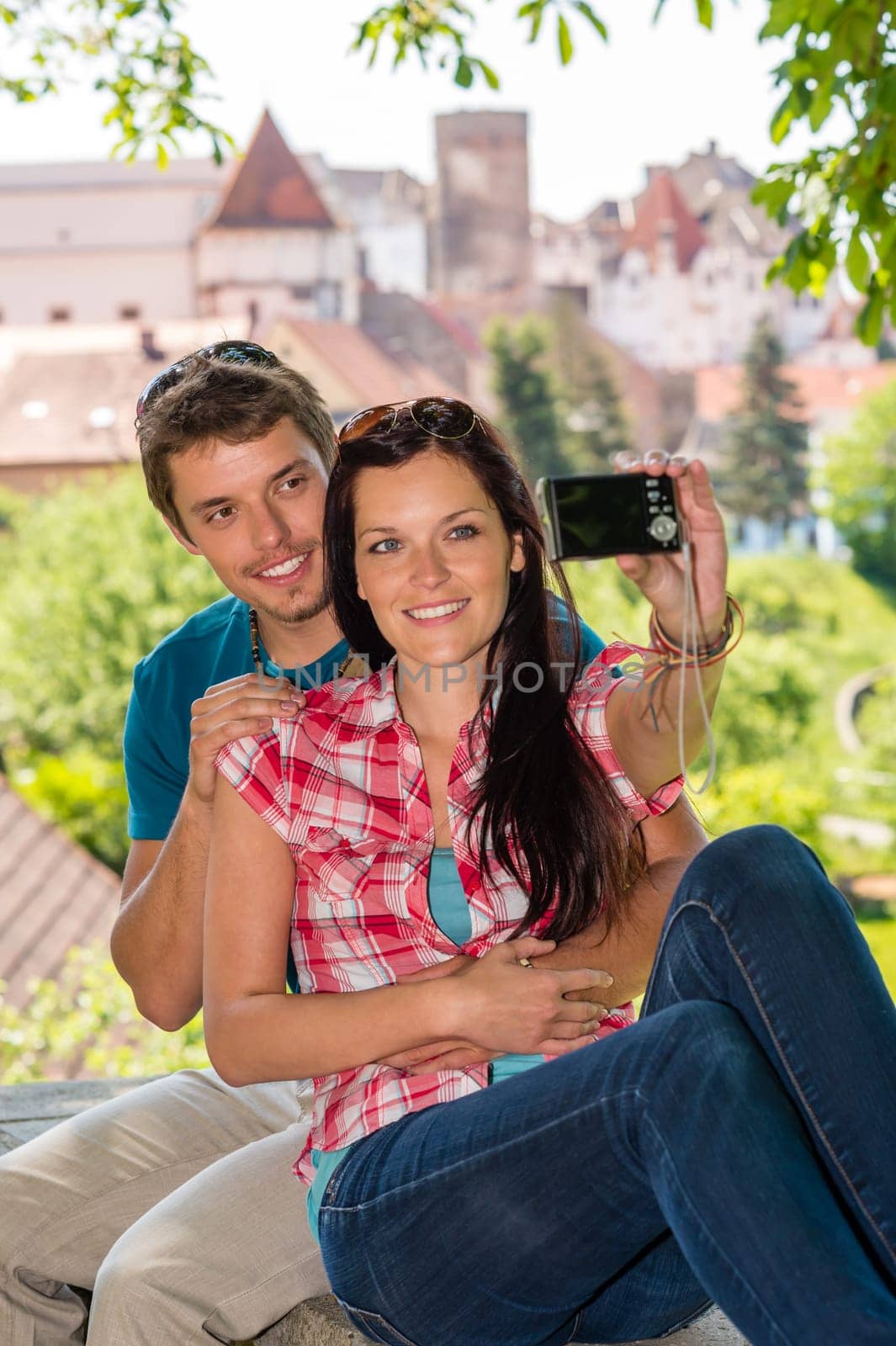 Happy young couple take photo of themselves smiling city tourists