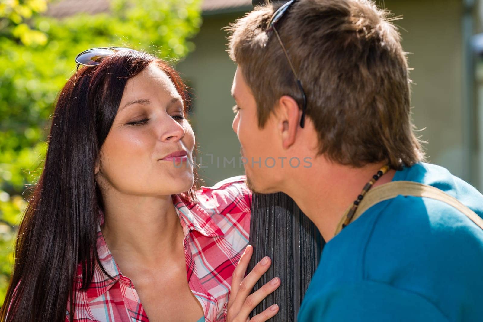 Young couple about to kiss on sunny day in park