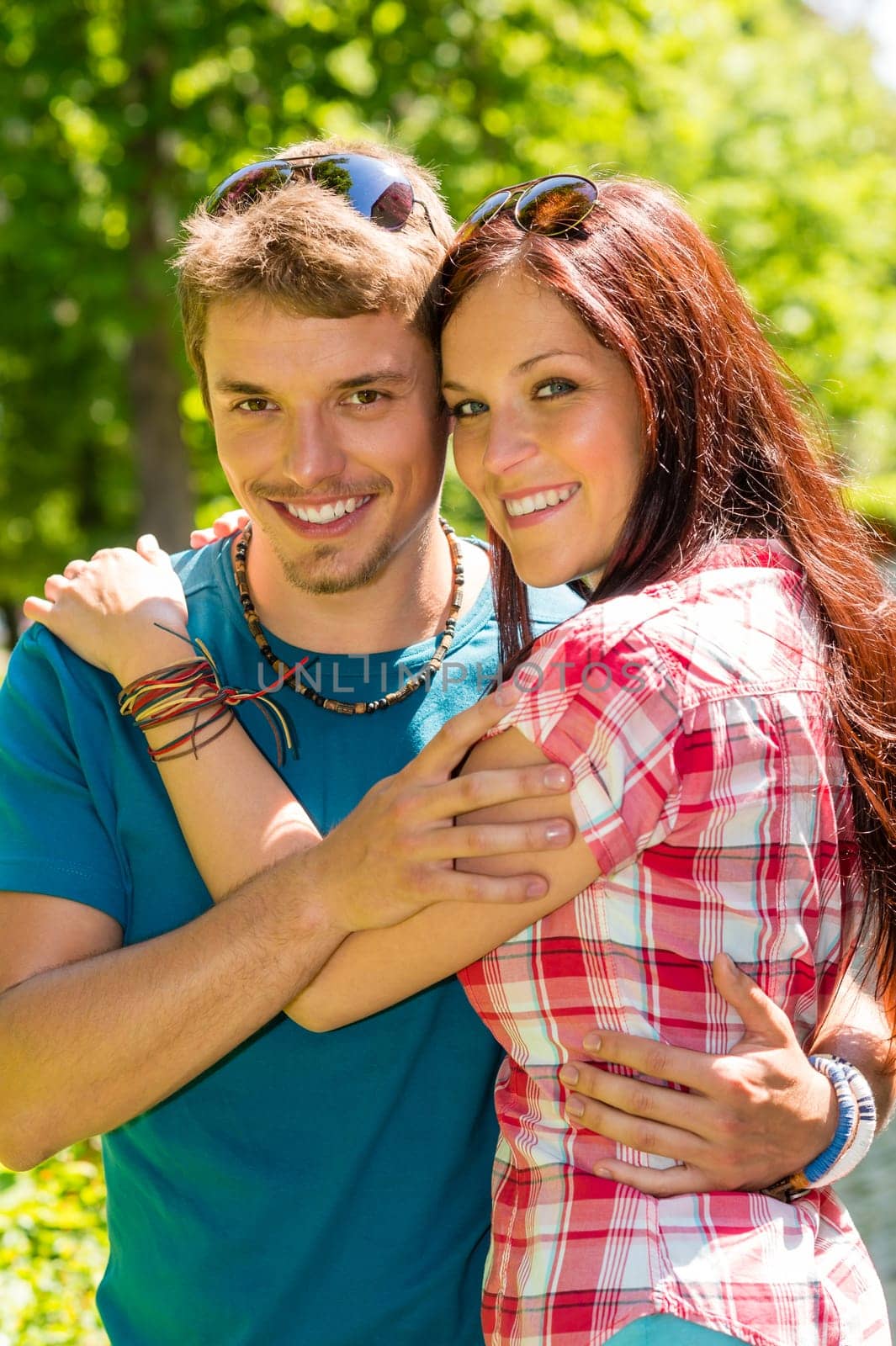 Young happy couple embracing in sunny park smiling pure romance
