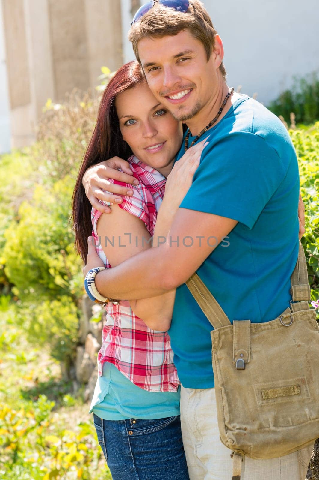 Young happy couple embracing in sunny park smiling pure romance