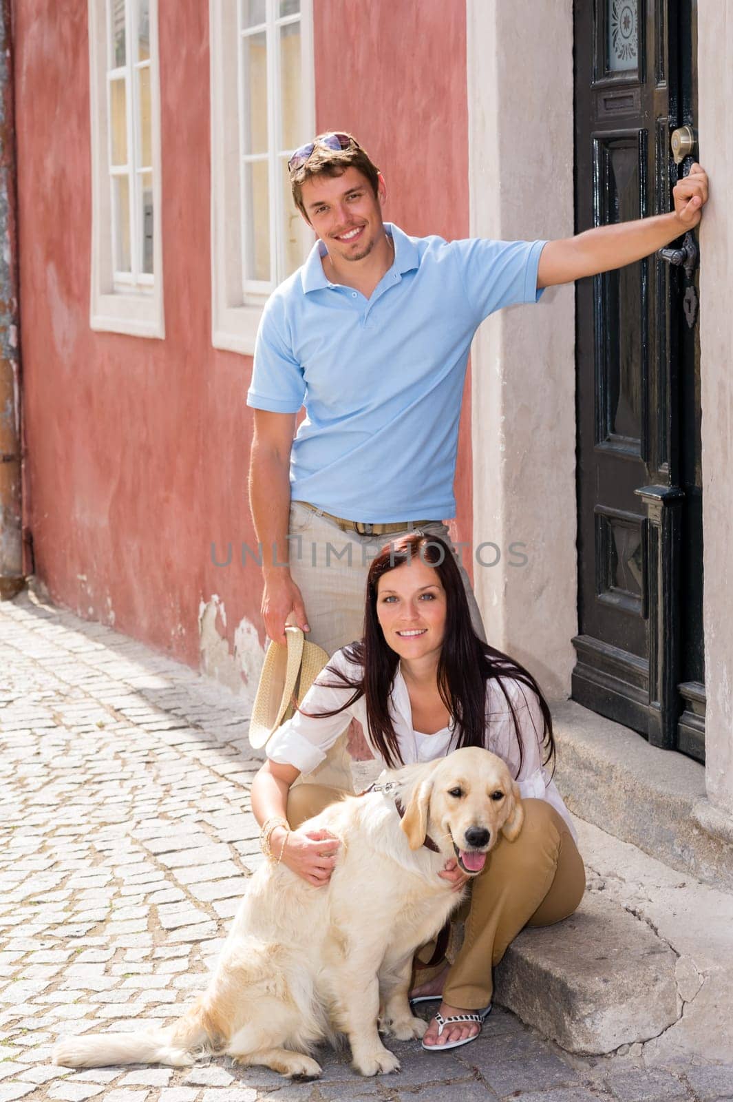 Young couple resting with dog on street stairs happy pet