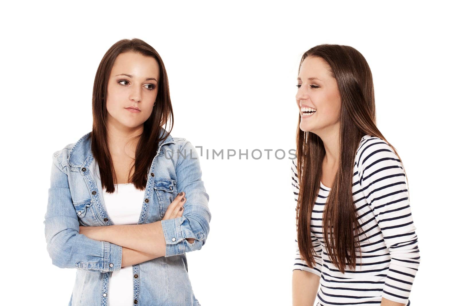 Girl laughing at her girlfriend on white background